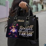 Outdoor lifestyle photo of glowing cross handbag carried by top handle on a city street.
