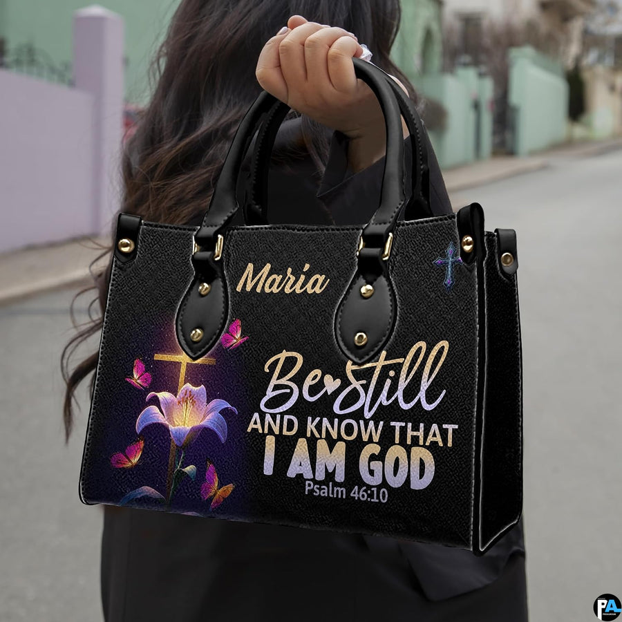 Outdoor lifestyle photo of glowing cross handbag carried by top handle on a city street.
