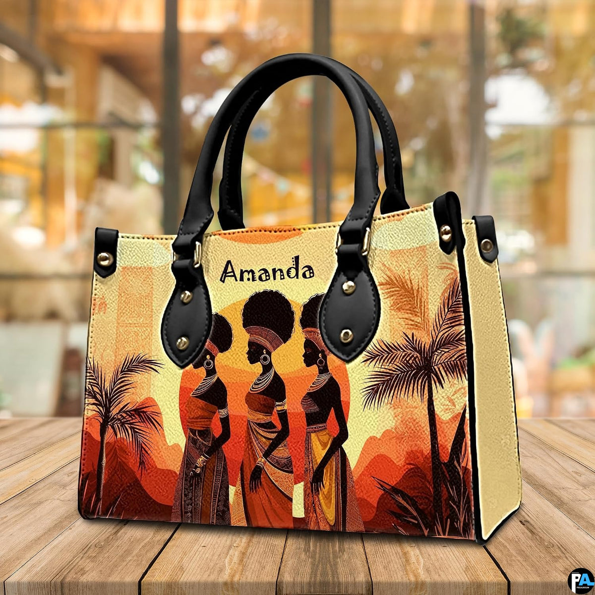 African women silhouette art shown resting upright on a polished wooden tabletop.