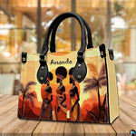 African women silhouette art shown resting upright on a polished wooden tabletop.