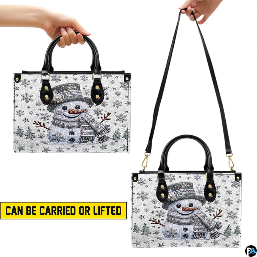 Matching elongated accessory decorated with sparkling crystal snowman and silver winter graphics.