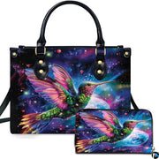 Cosmic galaxy handbag and matching wallet set featuring a glowing hummingbird against starry nebula.