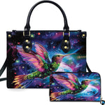 Cosmic galaxy handbag and matching wallet set featuring a glowing hummingbird against starry nebula.