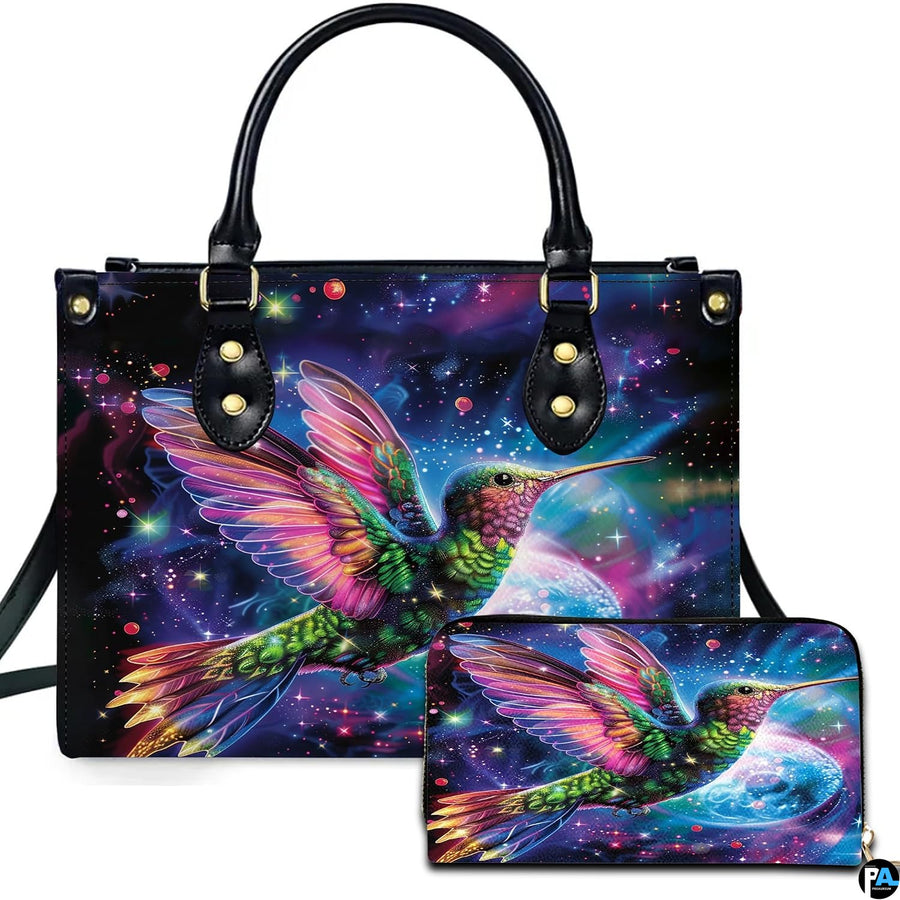 Cosmic galaxy handbag and matching wallet set featuring a glowing hummingbird against starry nebula.