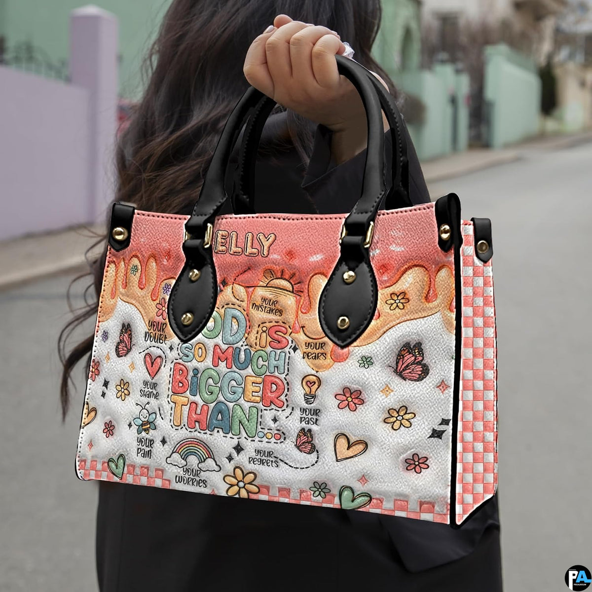 Angled display showing pastel doodle handbag beside matching personal organizer