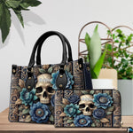 Gothic skull handbag and matching wallet shown on wooden table next to potted greenery.