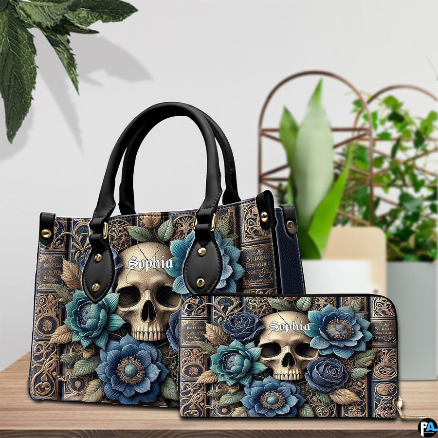 Gothic skull handbag and matching wallet shown on wooden table next to potted greenery.