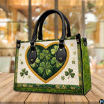 Angled clover heart handbag with layered green motifs on a tabletop