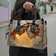 Model holding the Virgin Mary stone relief handbag outdoors on the street