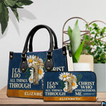 Navy handbag and matching zip wallet displayed together on wooden tabletop next to houseplant.