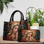 Handbag and matching wallet with mosaic Praying Mary artwork displayed beside tabletop plant.