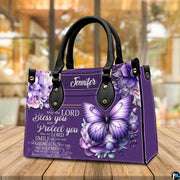 Top view showing carrying handles and main zippered opening of violet floral purse.