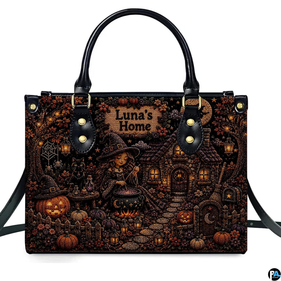 Front perspective of witch cottage art accessory featuring young spellcaster, glowing cauldron, and carved jack-o-lanterns.