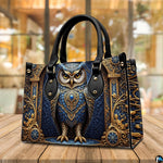 Side profile of baroque owl handbag showing continuous gilded acanthus scroll pattern along gusset
