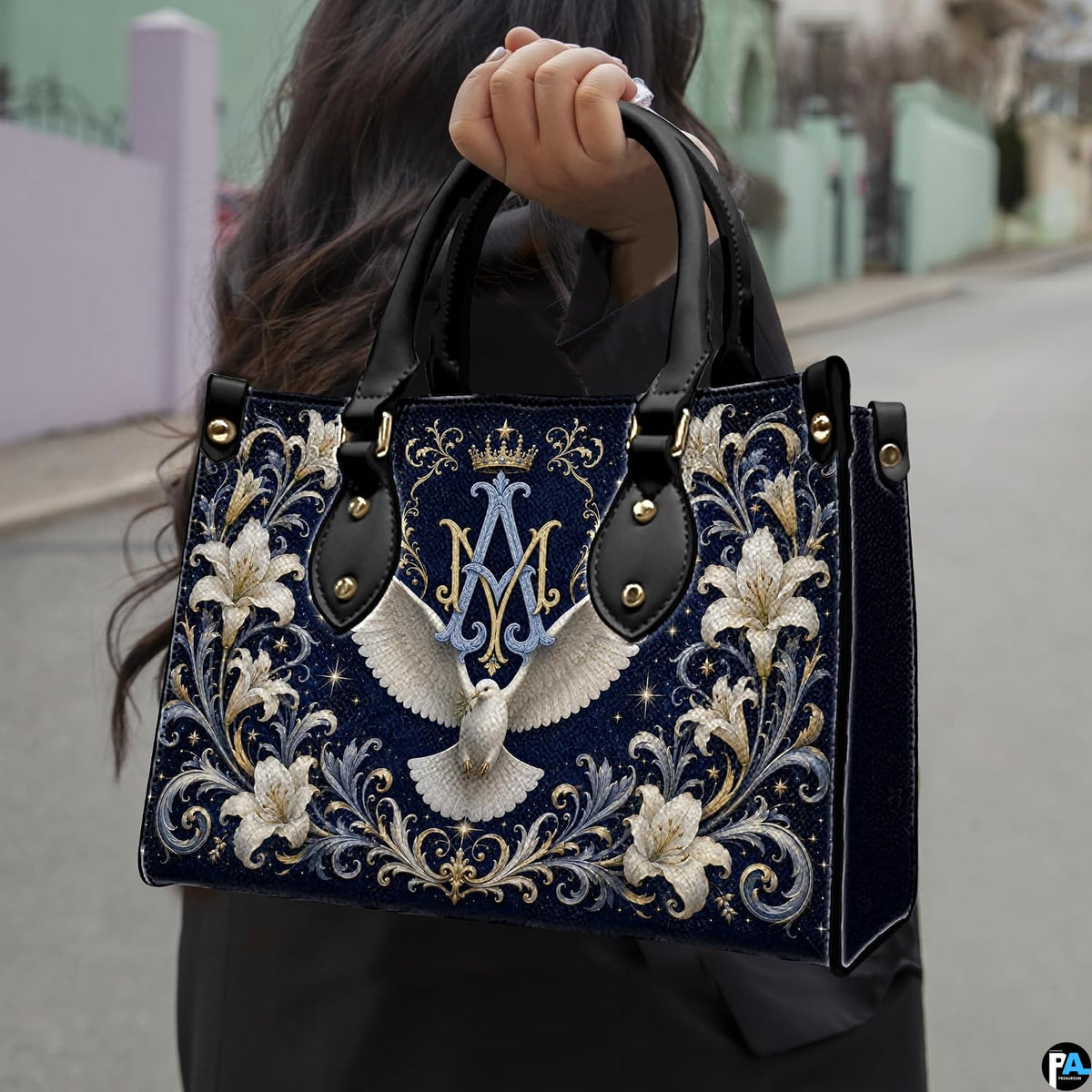 Lifestyle display of Marian crest handbag carried by model showing artwork and scale