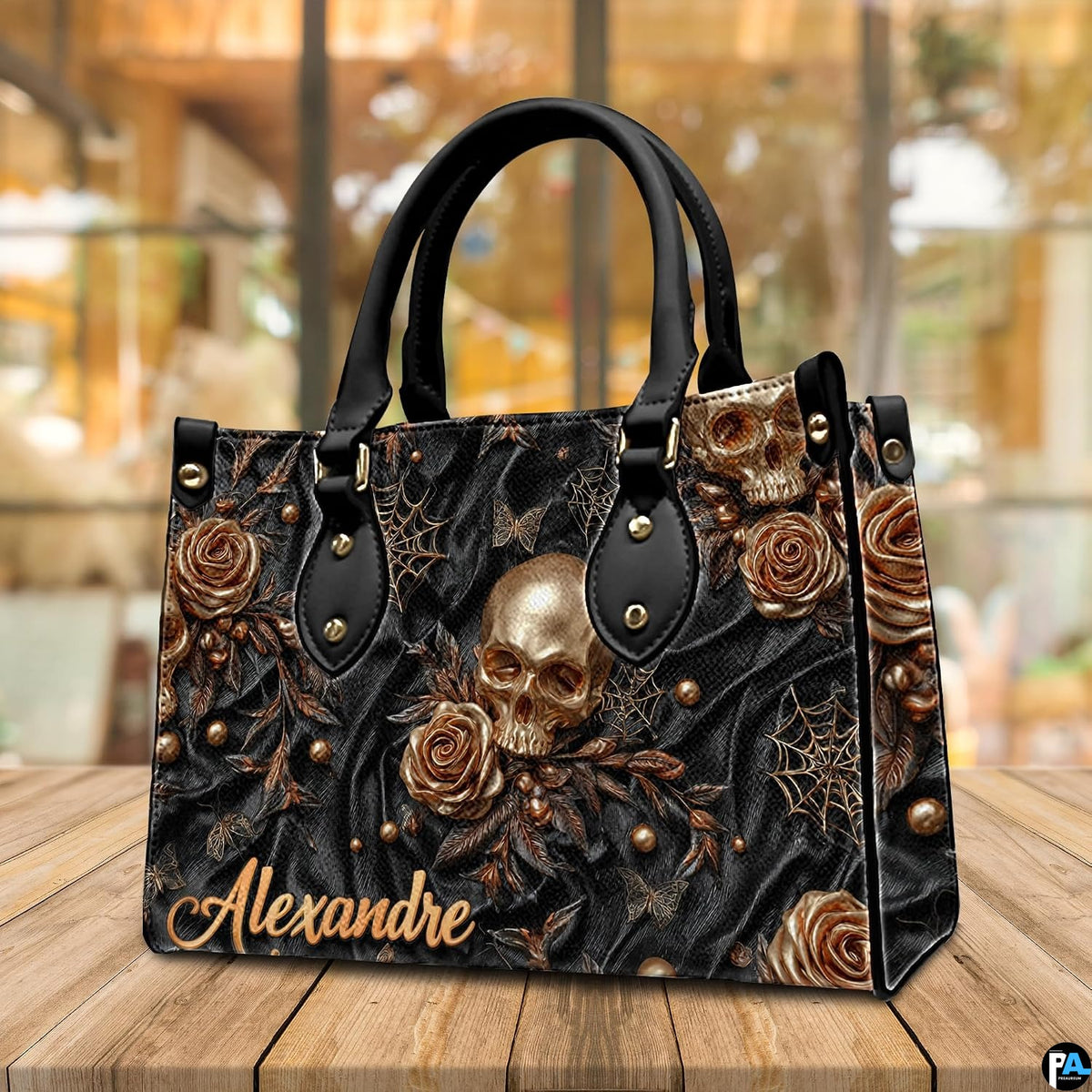 Golden skull handbag displayed on wooden plank table before indoor window.