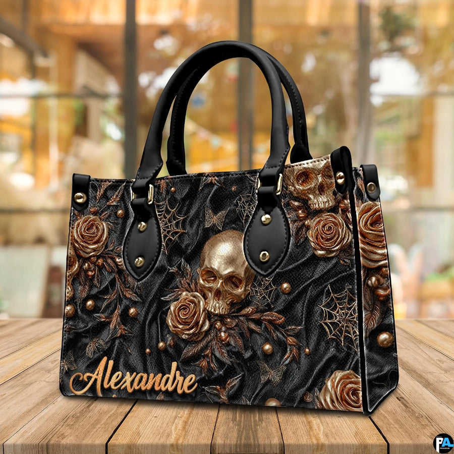 Golden skull handbag displayed on wooden plank table before indoor window.