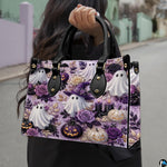 Cute ghost handbag carried outdoors by top handle on residential street.