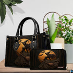 Gothic witch handbag and wallet displayed on wooden table beside potted plant.