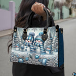 Front view of winter wonderland handbag displaying snowman family, frosted trees, and snowflake border.