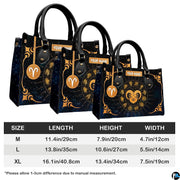 Golden celestial zodiac ram handbag paired with matching wallet against cosmic starry sky.