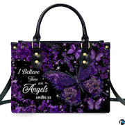 Angled perspective view of purple butterfly cross handbag highlighting sparkling botanical details.