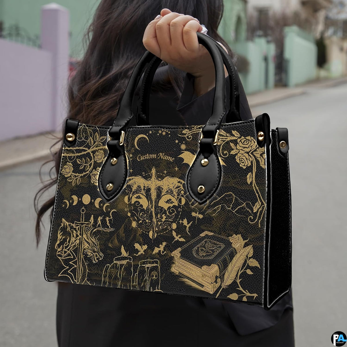 Golden dragon moon phases handbag carried outdoors along residential street.