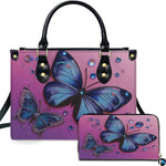 Front view of vibrant blue butterfly handbag and matching wallet set on magenta-to-purple ombre background.