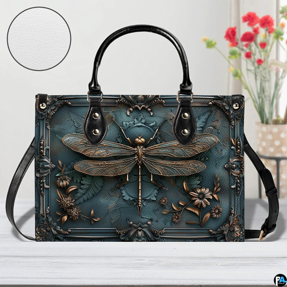 Bottom view of bronze dragonfly handbag showing protective metal feet studs and structured base wrap