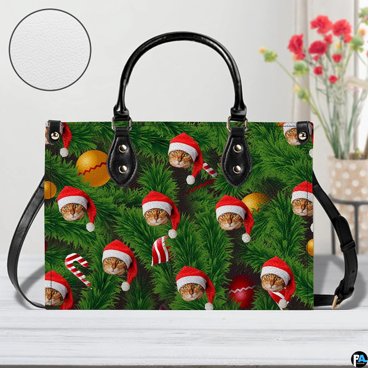 Front studio shot of structured holiday handbag showing Christmas tree pine needles and Santa cat motif