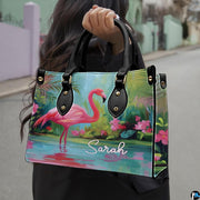 Outdoor lifestyle view of model carrying the tropical botanical flamingo handbag.