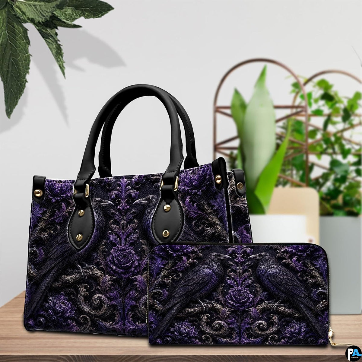 Still life tabletop arrangement showcasing the gothic raven art accessory alongside decorative foliage.