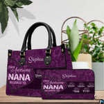 Side profile view of structured purple handbag showing sleek silhouette and black carrying handles.