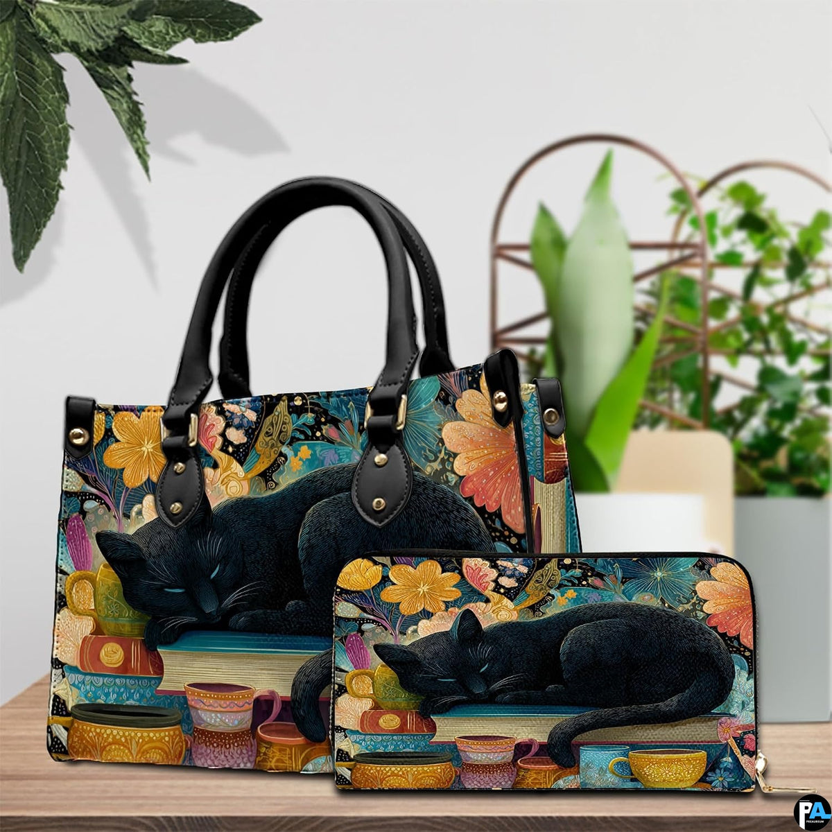 Cat sleeping on books art resting beside potted greenery on a rustic wooden table.