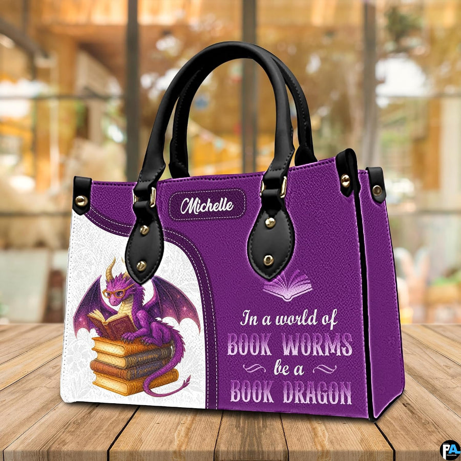 Three-quarter perspective view of purple dragon handbag on a rustic wooden table.