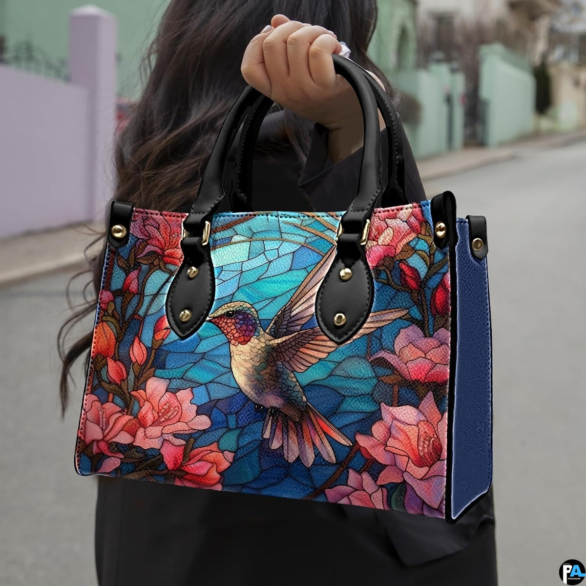 Angled view displaying the vibrant stained glass hummingbird and floral artwork across the front.