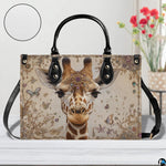 Perspective angle view of giraffe handbag showcasing side depth and patterned damask exterior.