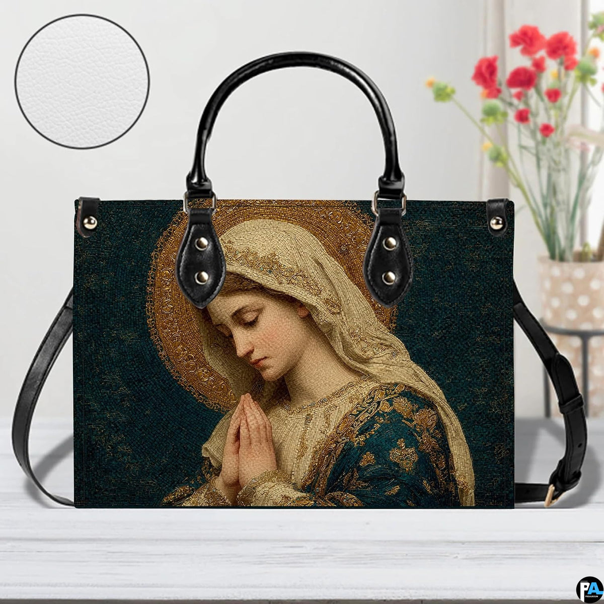 Devotional mosaic handbag displayed indoors beside a decorative flower vase