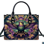 Studio front shot of handbag against white background highlighting purple hummingbird and lotus mandala.