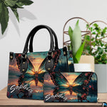 Front close-up view of handbag showing sunset butterfly scenery