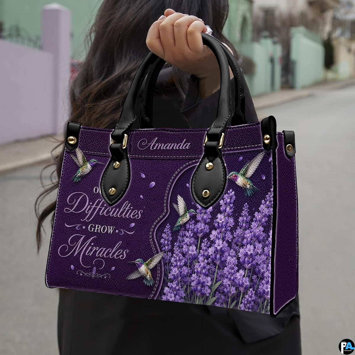 Angled view showing structured purple hummingbird and lavender handbag
