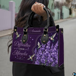 Angled view showing structured purple hummingbird and lavender handbag