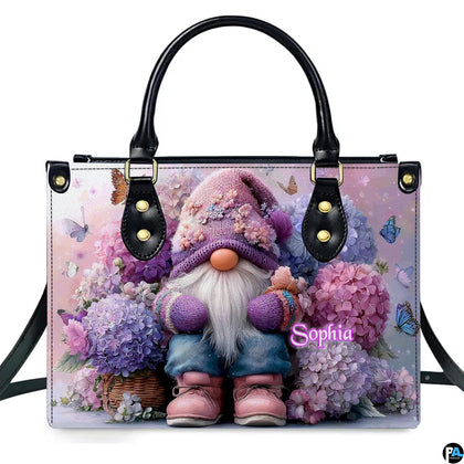 Front view of garden gnome and hydrangea handbag on white backdrop.