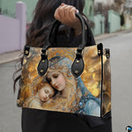 Model holding the bejeweled Virgin Mary and sleeping baby Jesus handbag outdoors on city street