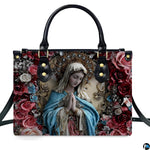 Front view highlighting praying Madonna artwork crowned with an ornate golden halo and surrounded by roses.
