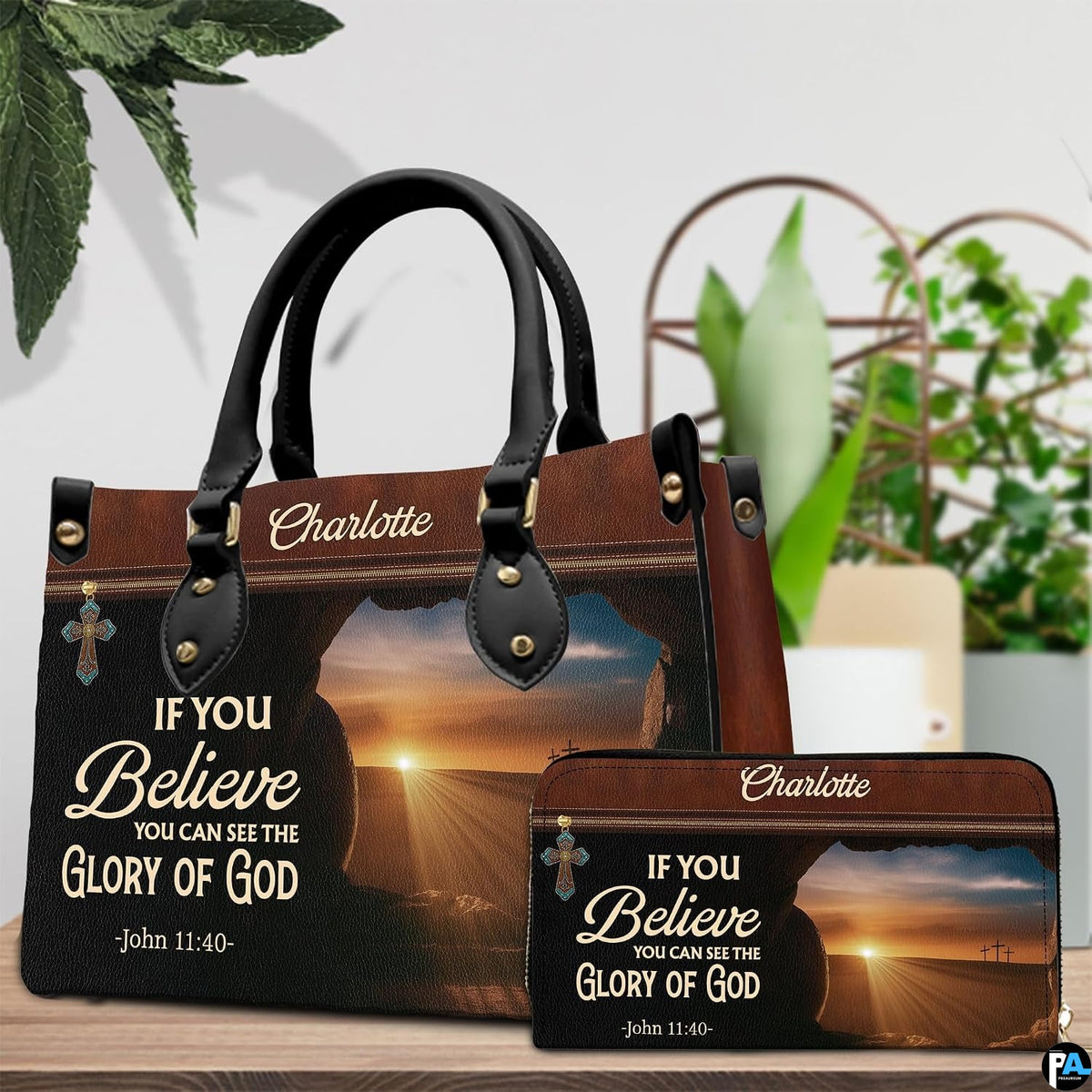 Detailed view of open cave entrance silhouette and radiant sunrise over three Calvary crosses on handbag.