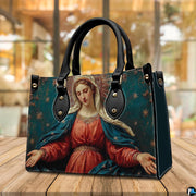 Madonna sacred art handbag displayed outdoors beside a cafe table setting