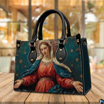 Madonna sacred art handbag displayed outdoors beside a cafe table setting