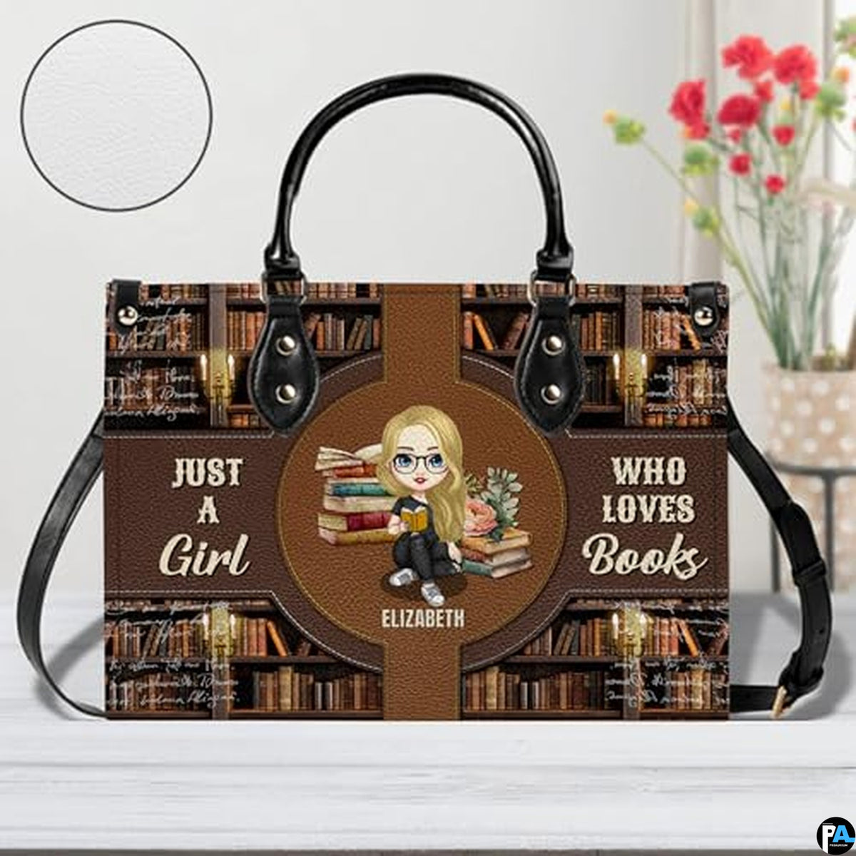 Front view of library bookshelf handbag displayed on tabletop near floral decor.