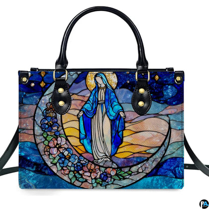 Stained glass art of the Virgin Mary on a floral crescent moon against a starry sky printed on a structured handbag.